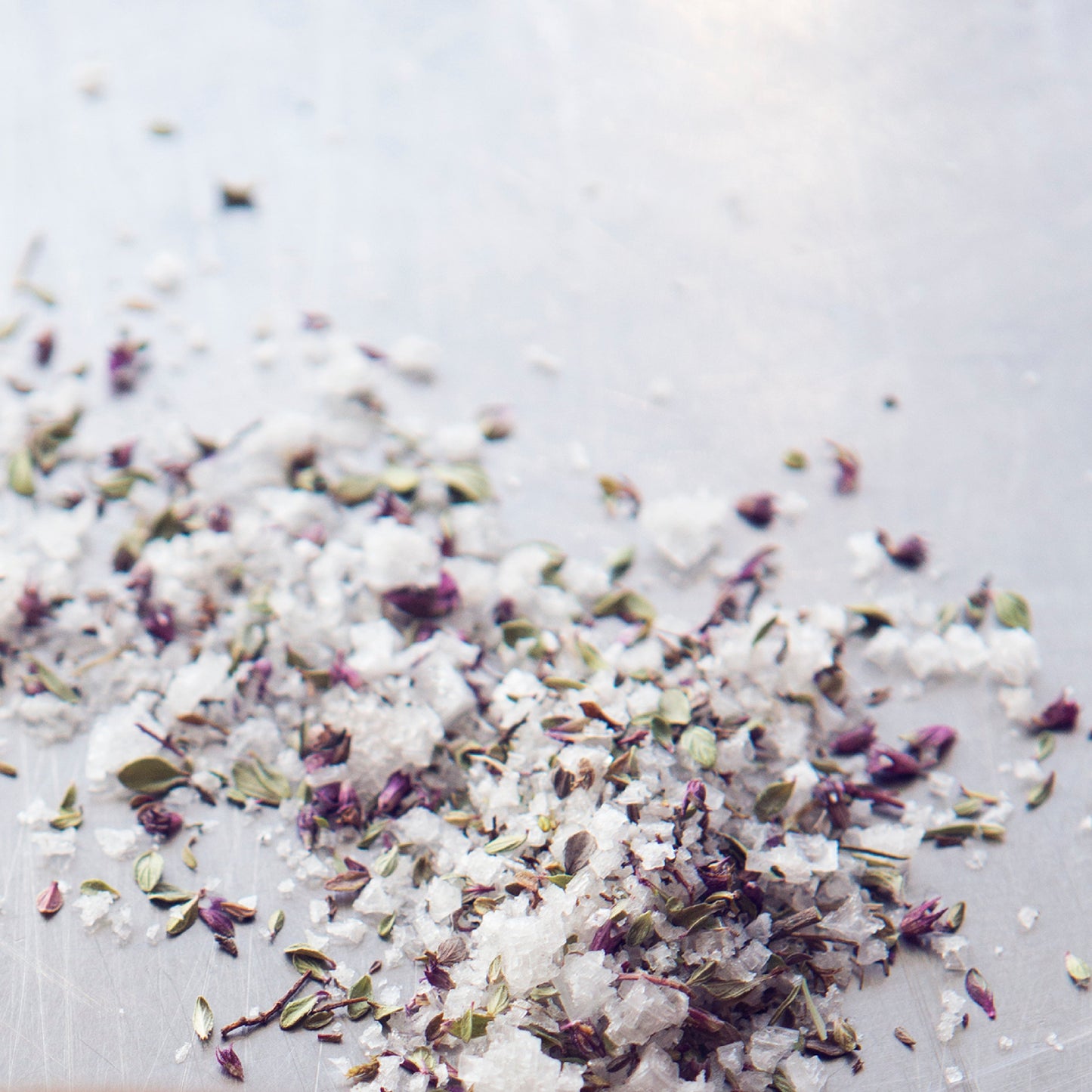 Herbal bath salt mix on a light background
