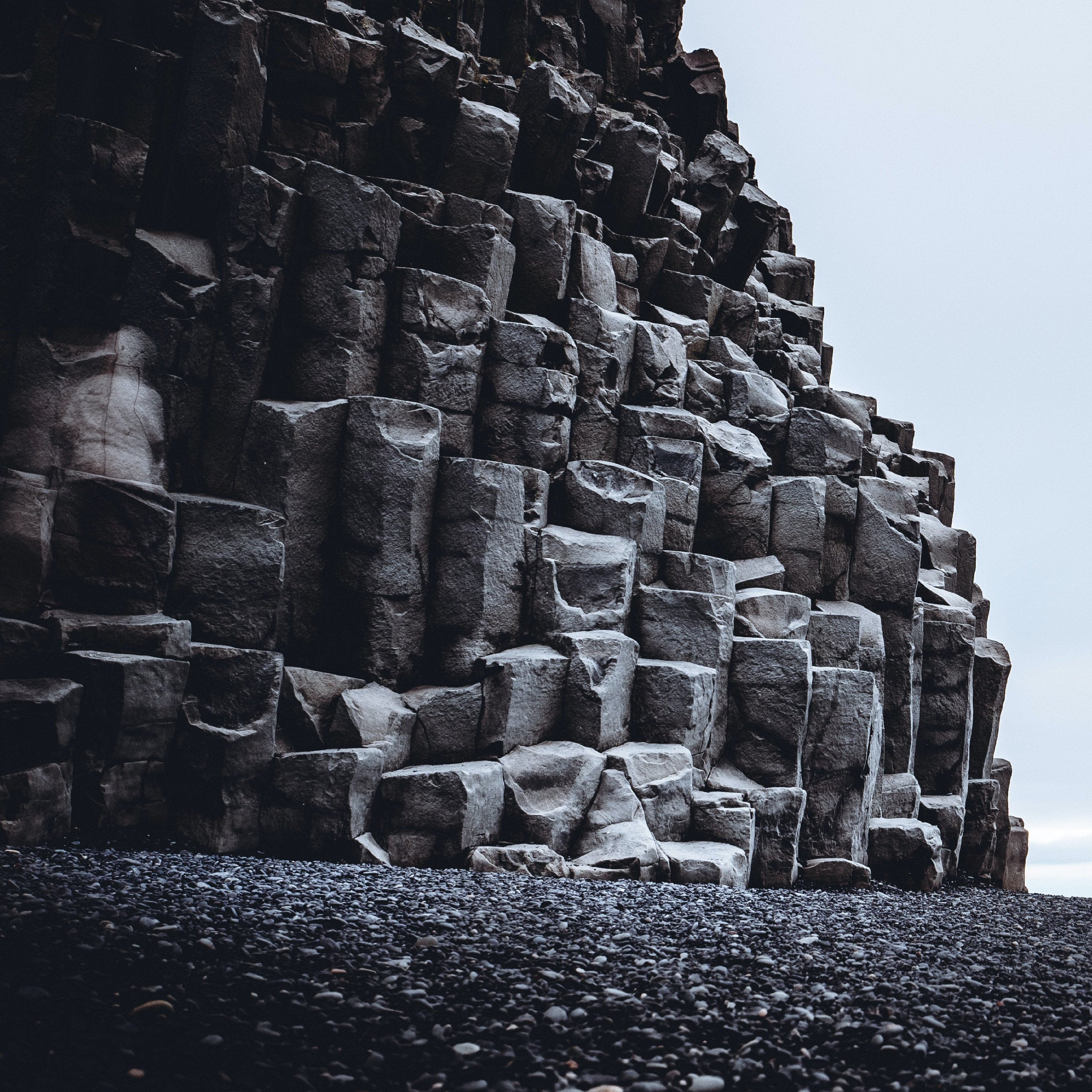 Geometric stone formation on a beach with a clear sky